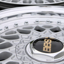 Load image into Gallery viewer, Close-up of BBS RS001 wheel with high polished lip and black/gold logo, featuring metallic silver powder-coated finish, 4x100 PCD.