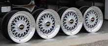 Load image into Gallery viewer, Set of four 15 inch BBS RS001 wheels with polished lips and metallic silver finish, ideal for classic cars, featuring black and gold logos.