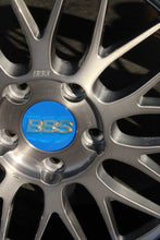 Load image into Gallery viewer, Close-up of 19" BBS LM wheel with brushed finish and blue center cap, featuring intricate spoke design.