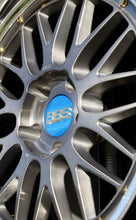 Load image into Gallery viewer, Close-up of a 19-inch BBS LM227/228 wheel with a brushed finish and blue center cap, featuring a 5x120 bolt pattern.