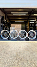 Load image into Gallery viewer, Four BBS LM wheels for Porsche 997 widebody, black and blue finish, displayed in a garage