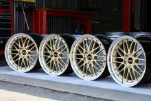 Load image into Gallery viewer, Set of 20-inch BBS LM471 and LM472 wheels, gold finish with polished lip, designed for Porsche 991 fitment, showcased in workshop.