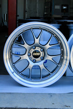 Load image into Gallery viewer, 20" BBS LM-R wheel with diamond black disk and silver diamond-cut rim, designed for F8X M fitment, on display in a garage setting
