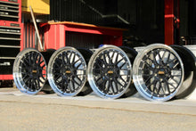 Load image into Gallery viewer, 19-inch BBS LM wheels in black and blue finish for Porsche 997 wide body, shown in garage with diamond cut rim.