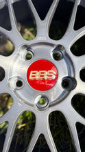 Load image into Gallery viewer, Close-up of a 19-inch BBS LM wheel with brushed finish, featuring a red center cap and intricate spoke design, perfect for high performance.