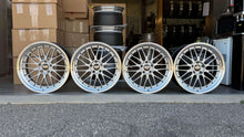 Load image into Gallery viewer, Four 20-inch BBS LM225 wheels with gloss silver finish, compatible with BMW models, displayed in a garage setting.