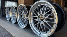 Load image into Gallery viewer, Four 20-inch BBS LM225 wheels with gloss silver finish, compatible with BMW models, displayed in a row on a concrete floor.