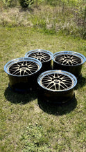 Load image into Gallery viewer, Set of four BBS LM471 wheels on grass, featuring two-piece forged construction for high-performance vehicles with 5x130 bolt pattern.
