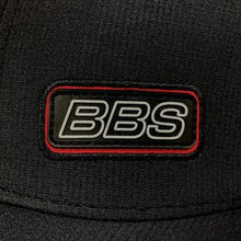 Load image into Gallery viewer, Close-up of BBS cap featuring a black silicone logo with red accents, part of the &quot;Est. 1970&quot; collection, on black fabric.
