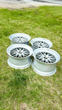 Load image into Gallery viewer, Set of four 19-inch BBS LM272 wheels with classic mesh design, ideal for E46 M3 and E9X M models, placed on a grassy lawn.
