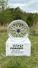 Load image into Gallery viewer, 19-inch BBS LM272 silver wheel displayed on box in outdoor setting
