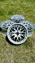 Load image into Gallery viewer, 16-inch BBS RG-F wheels in brilliant silver finish, perfect fit for E30 BMW, lightweight die forged aluminum, set of four on grass.
